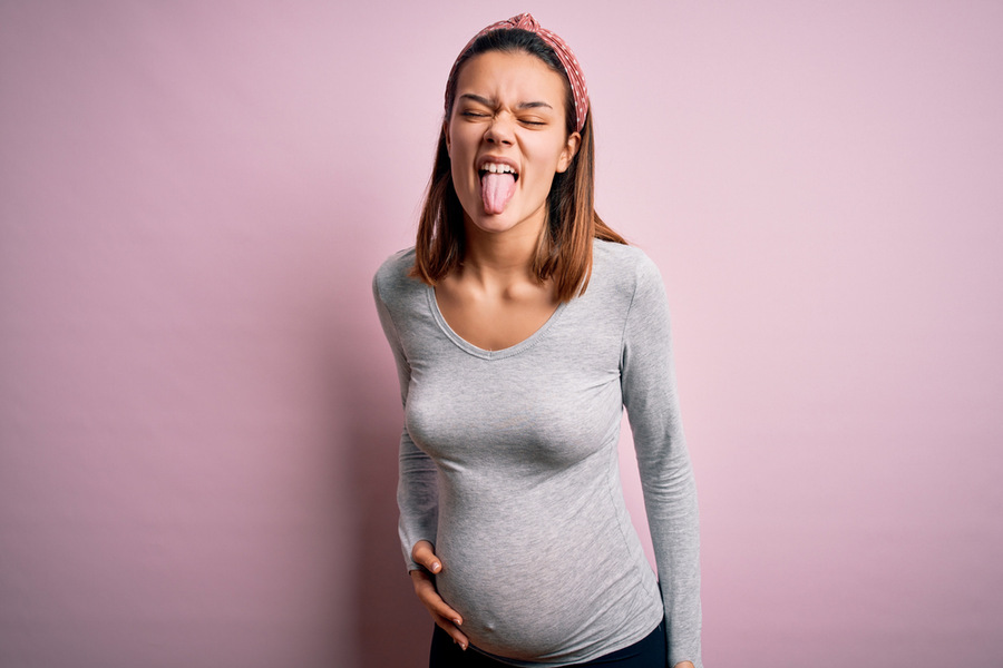 Pregnant woman sticking tongue out