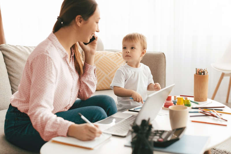 Mum Working With Toddler